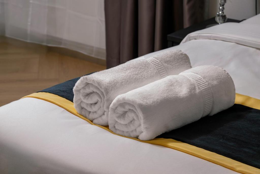 a rolled up towel on the edge of a bed at BRYQS Hotel KL Sentral in Kuala Lumpur