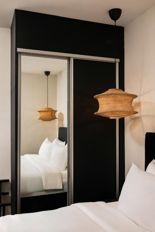 a bedroom with a mirror and a bed at BRYQS Hotel KL Sentral in Kuala Lumpur
