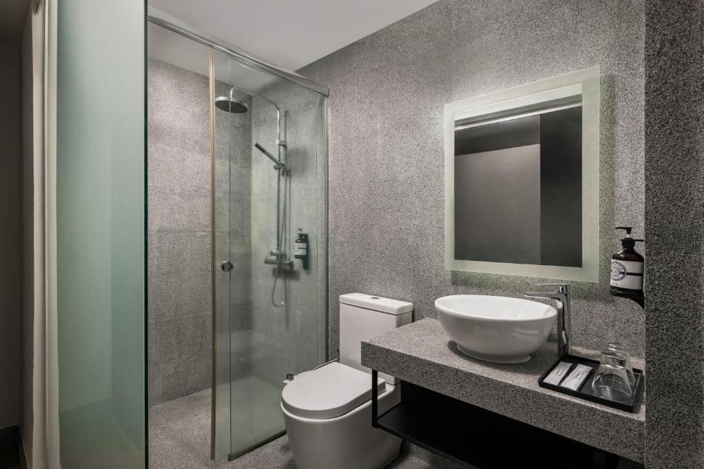 a bathroom with a toilet and a sink and a shower at BRYQS Hotel KL Sentral in Kuala Lumpur
