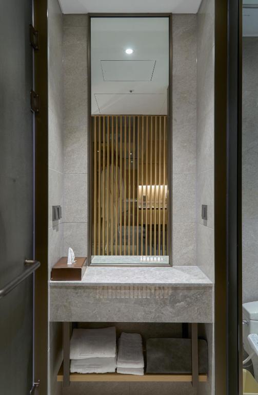 a bathroom with a sink and a mirror at Mayfield Hotel Seoul in Seoul