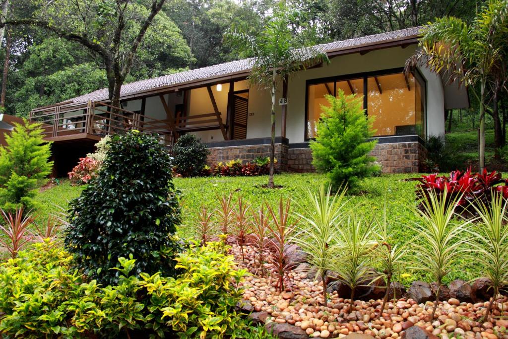 a house with a garden in front of it at The IBNII - Eco Luxury Resort in Madikeri