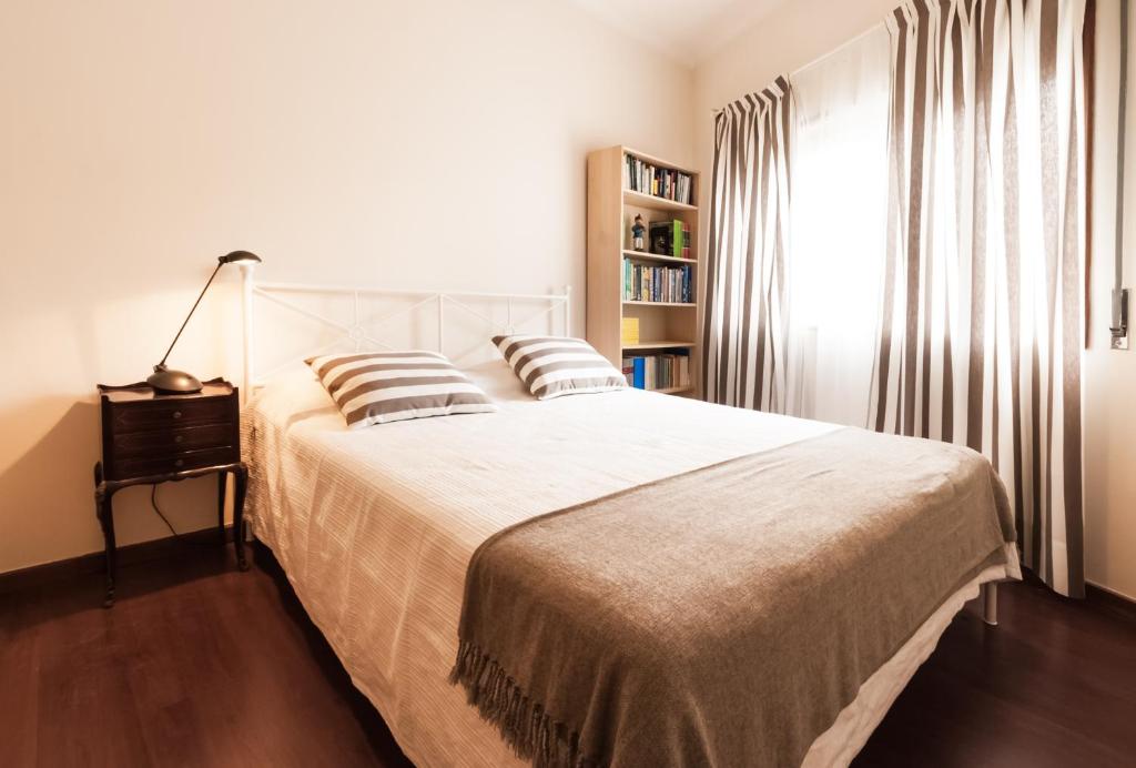 a bedroom with a large white bed with pillows at BmyGuest - Santa Catarina Apartments in Porto