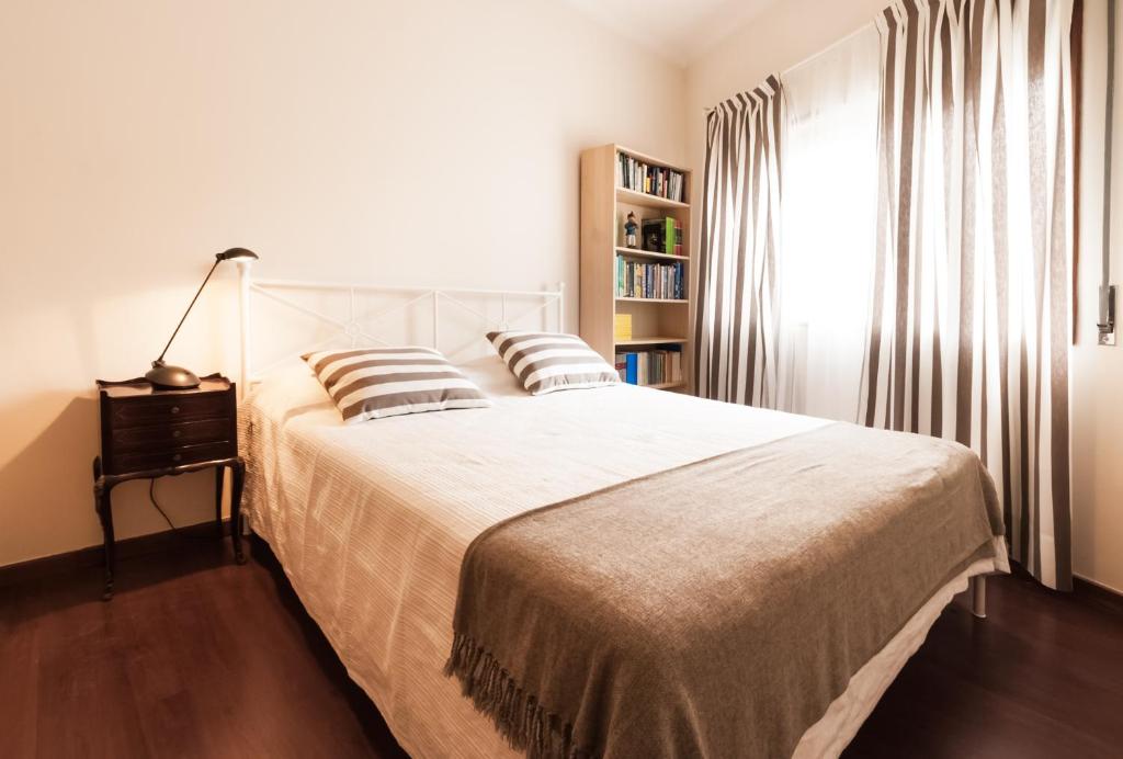a bedroom with a large white bed with pillows at BmyGuest - Santa Catarina Light Apartment in Porto