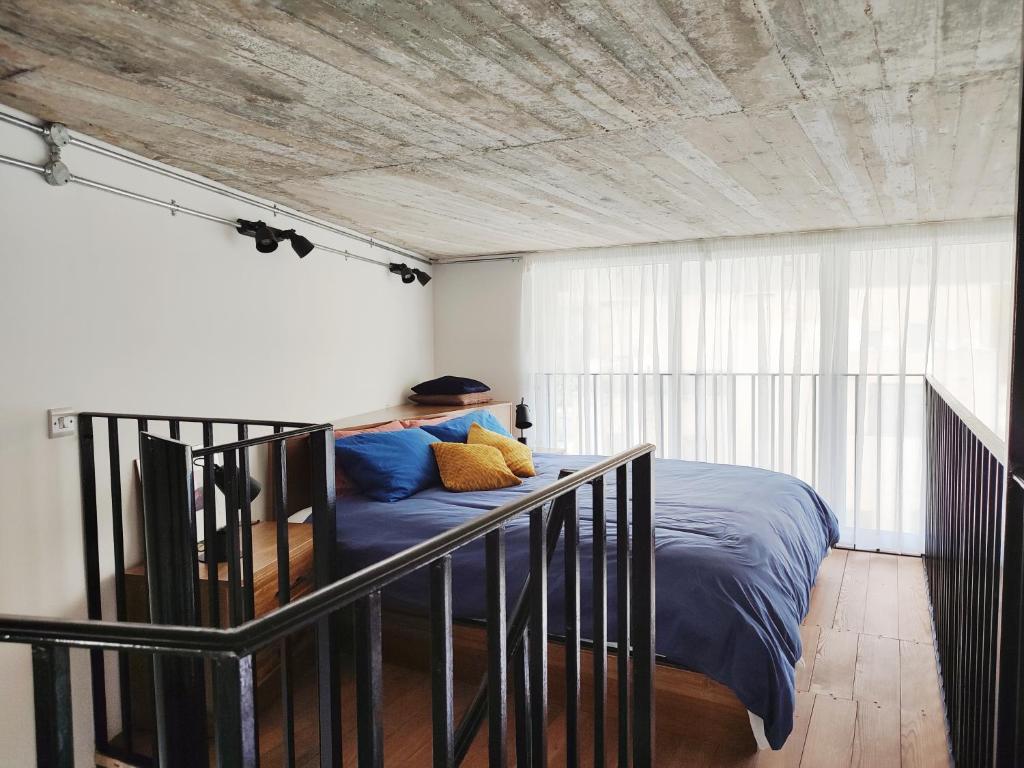 a bedroom with a bed with a wooden ceiling at Xlendistays - Centrally located Seafront living holiday spaces in Xlendi in Xlendi