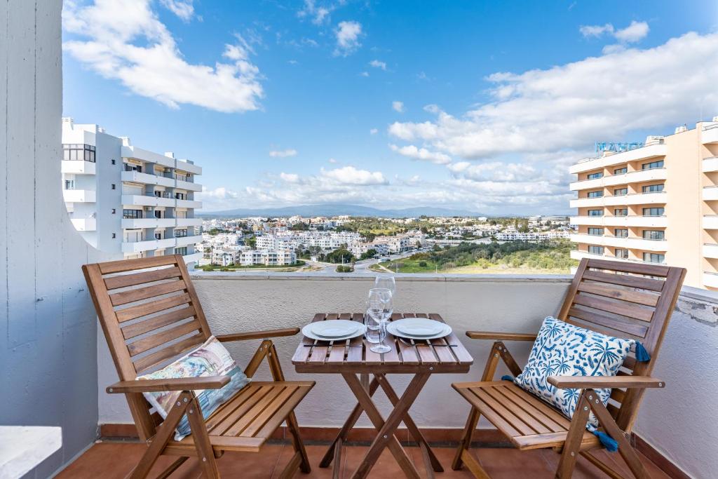 two chairs and a table on a balcony with a view at Gaivotas House in Alvor