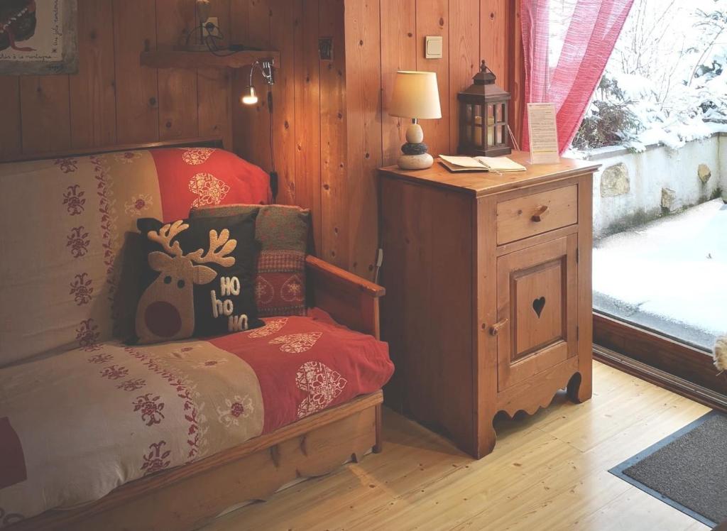 a bedroom with a bed with a moose pillow on it at GITE "POM DE PIN" avec accès à la balnéo et piscine couverte - Libre du samedi au samedi in Longchaumois