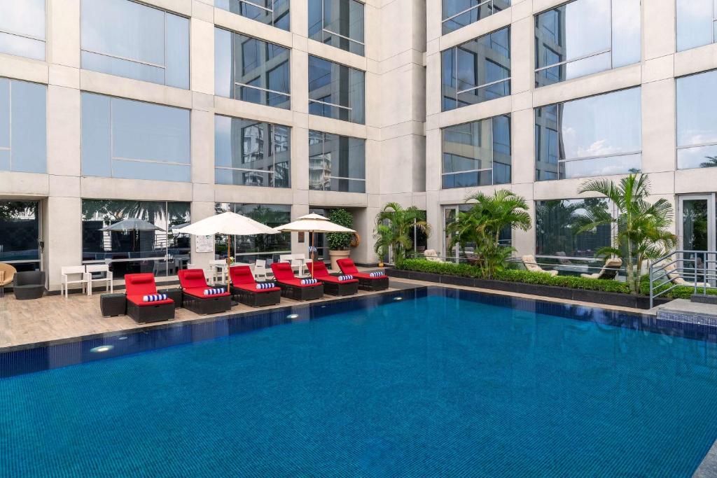 a large swimming pool in front of a building at Hyatt Regency Lucknow Gomti Nagar in Lucknow