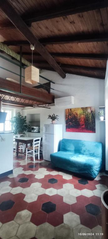 a living room with a blue couch and a table at Bike NIGHT-bike friendly, cozy loft, Finale Ligure in Finale Ligure