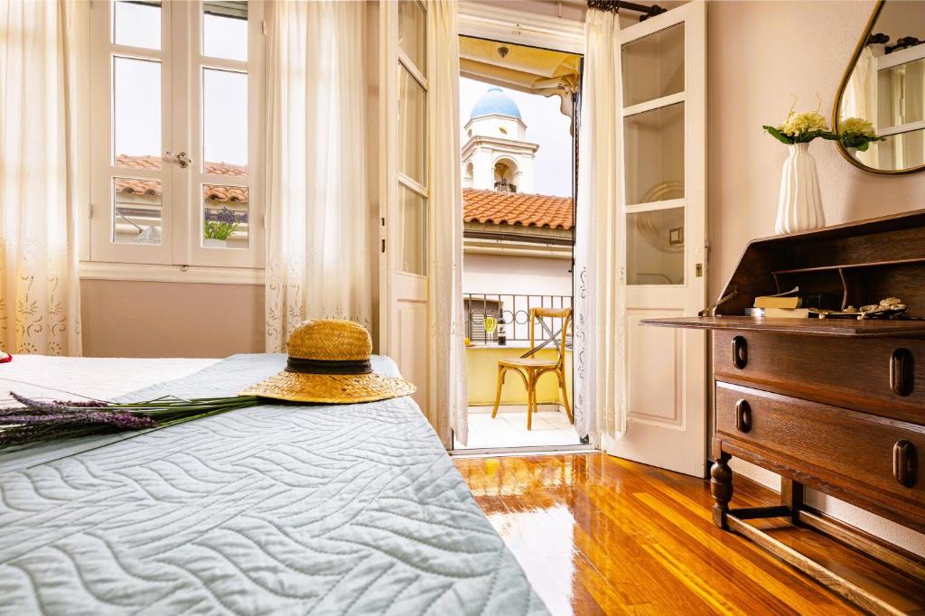 a bedroom with a bed with a hat on it at Chanialiving Venetian Luxury House-near Plaza Parking in Chania Town