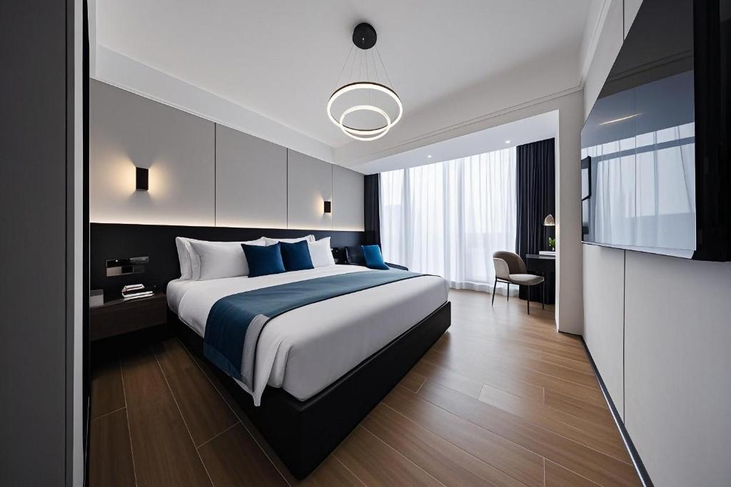 Postel nebo postele na pokoji v ubytování 颐程City View Hotel-广州太古汇珠江新城体育中心石牌桥地铁站店-广交会专享