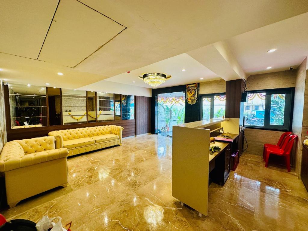 a large living room with couches and a desk at Shyanu Lords Eco Inn Airoli-Near Mindspace in Navi Mumbai
