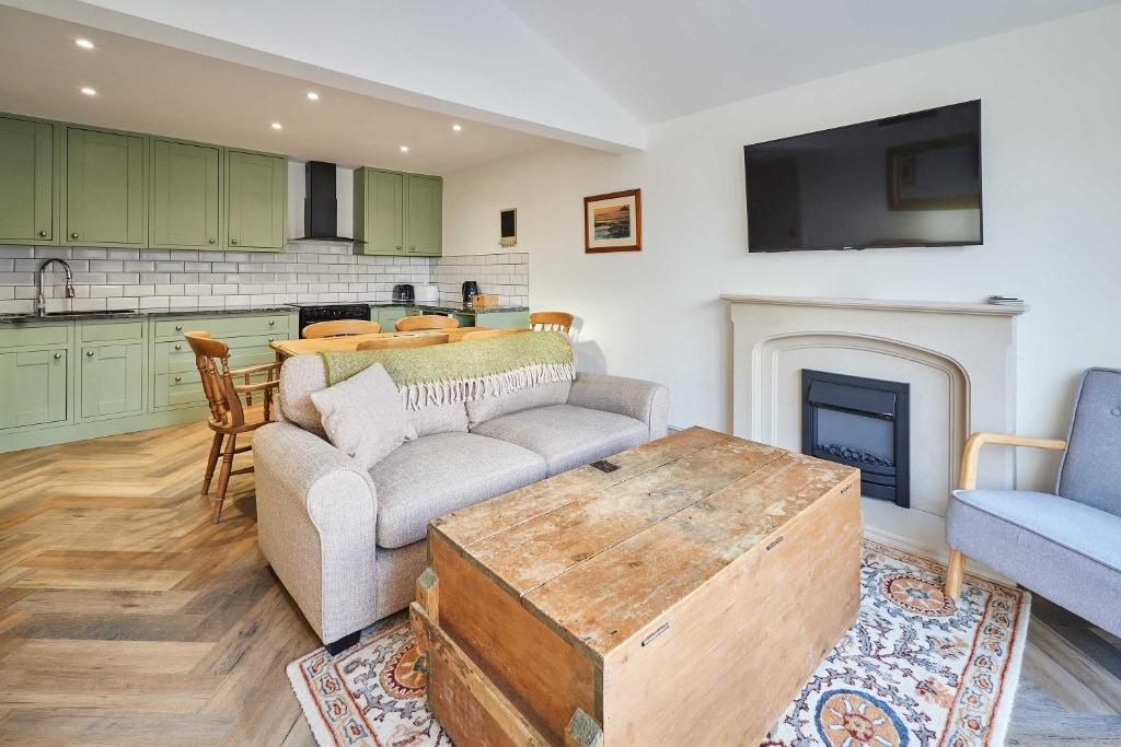 a living room with a couch and a table at Host & Stay - Middle Cottage in Seahouses