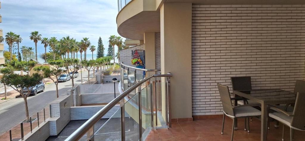 a balcony with a view of a street and palm trees at Marina d'Or Edificio Fase X - 1ª linea apartment in El Borseral