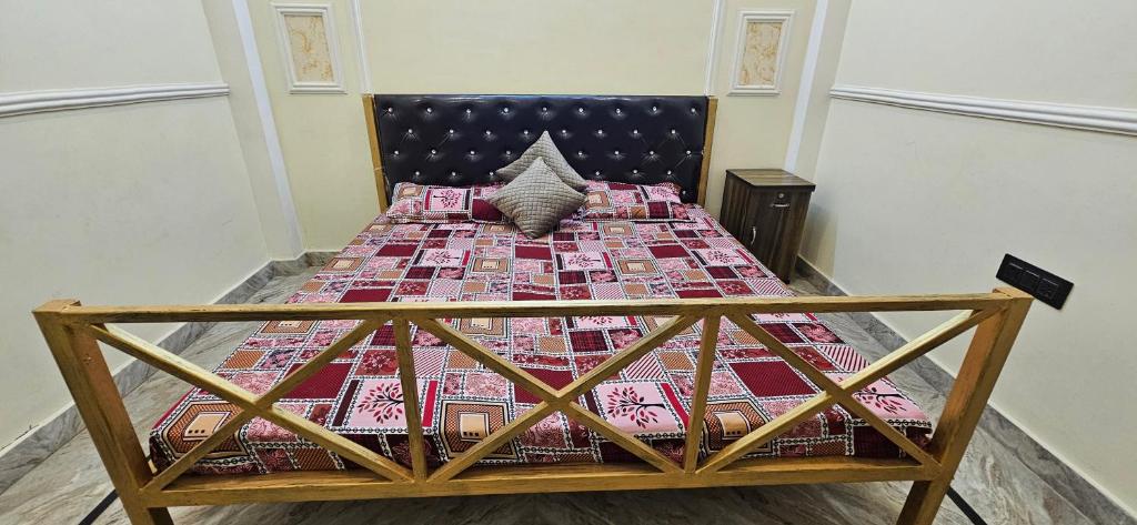 a bed with a quilt on it in a room at Blessing's Home Stay 5 Bedrooms Luxury Villa Exquisite 5 Bedroom Villa Ideal Family Home Stay with Spacious Living in Lucknow