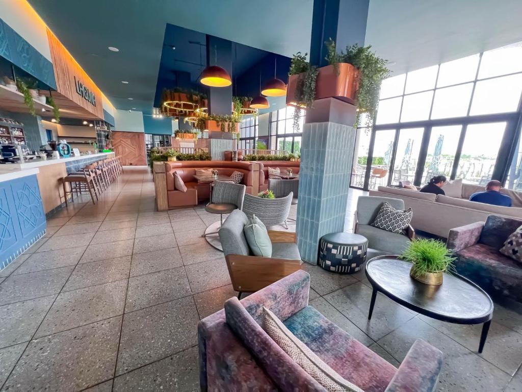 a lobby with couches and tables in a restaurant at Ls apartment in Midrand