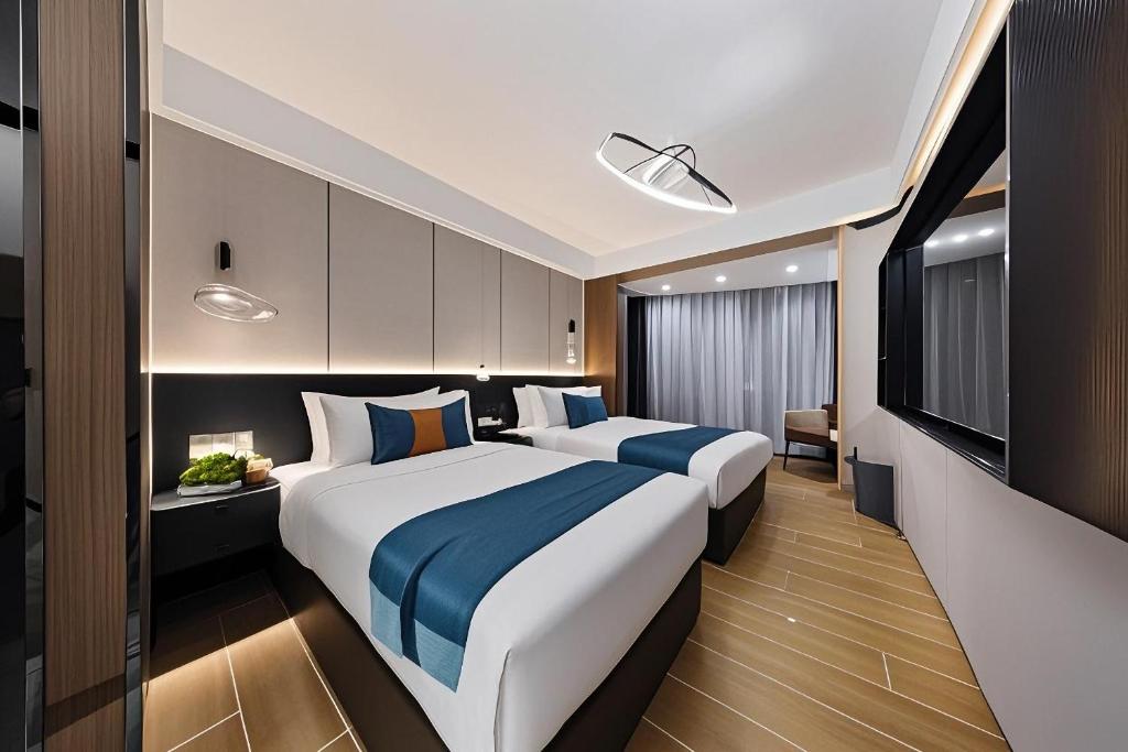 Postel nebo postele na pokoji v ubytování 颐程City View Hotel-广州太古汇珠江新城体育中心石牌桥地铁站店-广交会专享