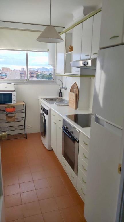 A kitchen or kitchenette at MIAMI PLAYA SIRENS en Cala Sirenas FREE WIFI