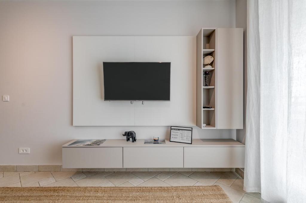 Televízia a/alebo spoločenská miestnosť v ubytovaní Apartment Stiv Luxe