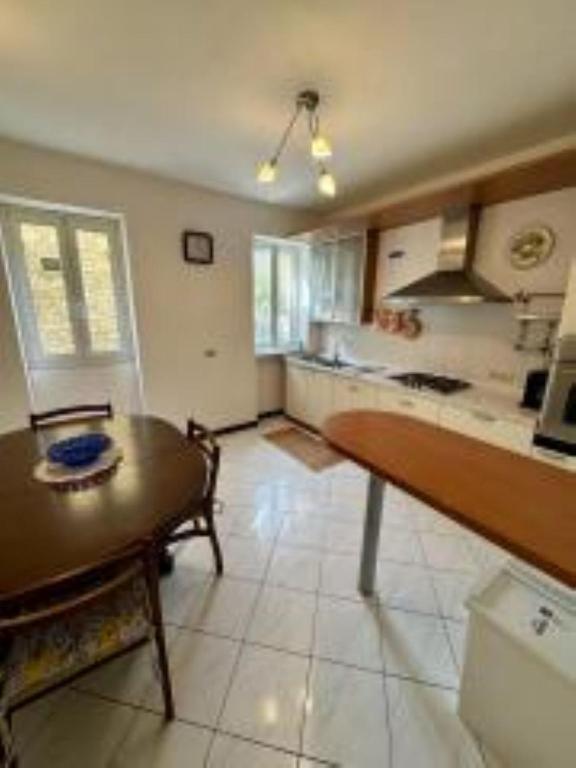 a large kitchen with a table and a counter top at Casa Fabrizio in Villa Viani