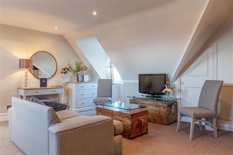 a living room with a couch and a tv at Botany Bay Hotel in Broadstairs