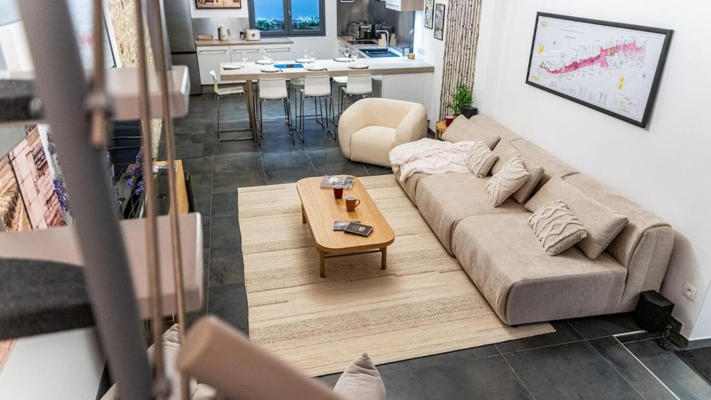 un soggiorno con un divano e un tavolo di La Maison Mercier a Digione