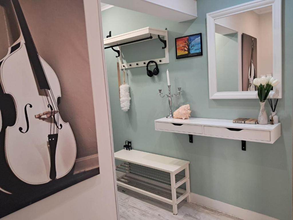 a bathroom with a guitar on the wall and a mirror at Varna Moreto in Varna City