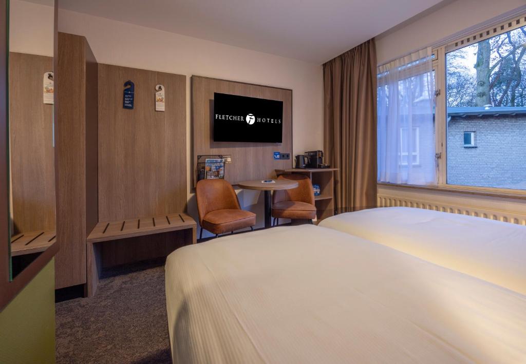 TV a/nebo společenská místnost v ubytování Fletcher Parkhotel Val Monte