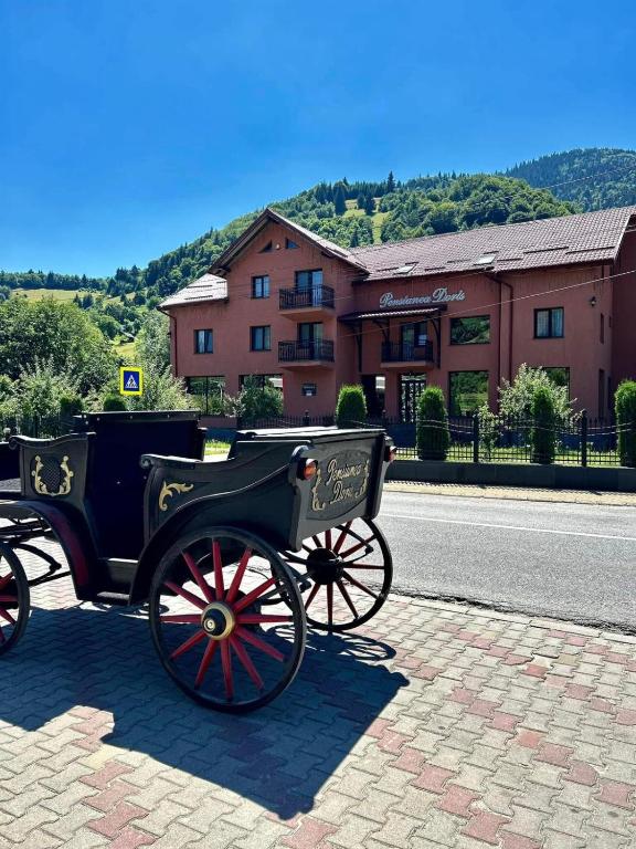 a horse drawn carriage on the side of the road at Pensiunea Doris in Rodna