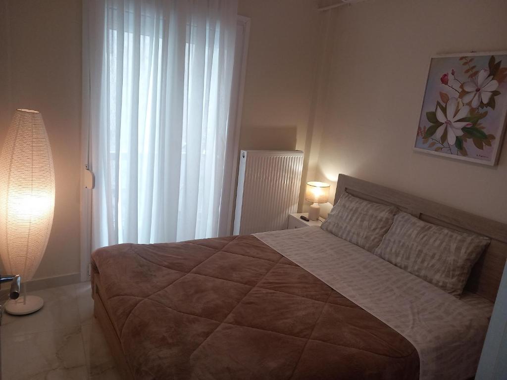 ein Schlafzimmer mit großem Bett und Fenster in der Unterkunft Eva's Sweet Home in Thessaloniki
