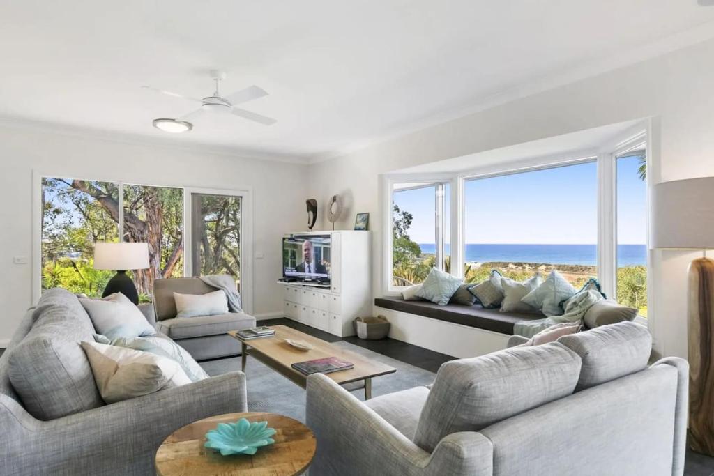 a living room with two couches and a television at Bimbadeen Luxurious Retreat in Aireys Inlet