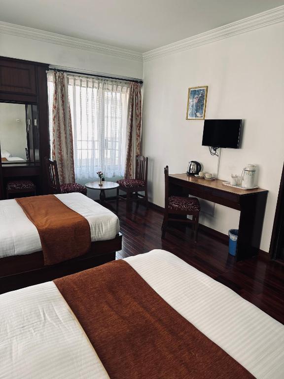 Postel nebo postele na pokoji v ubytování Fuji Hotel