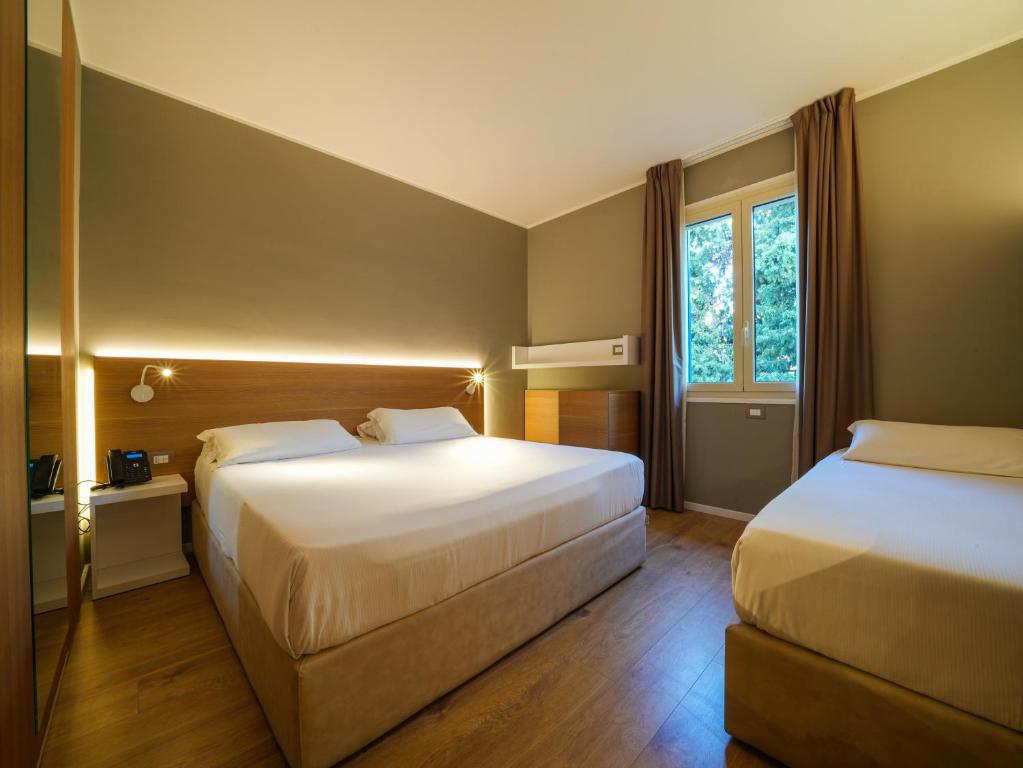 Postel nebo postele na pokoji v ubytování Hotel Club Lacona