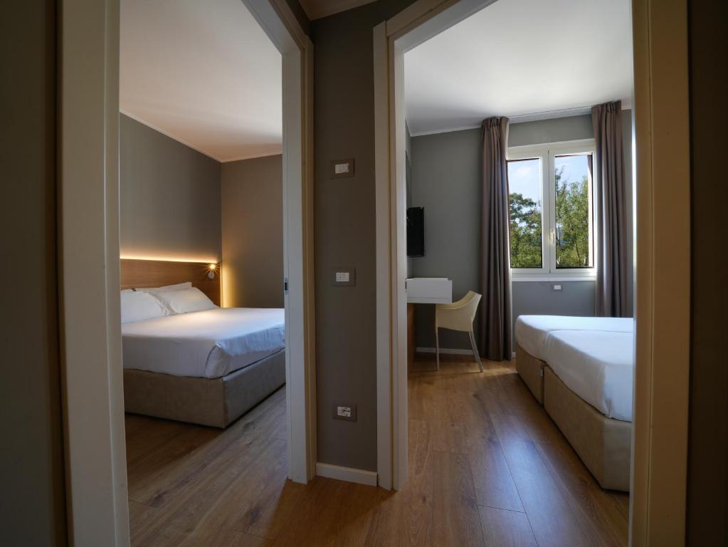 Postel nebo postele na pokoji v ubytování Hotel Club Lacona