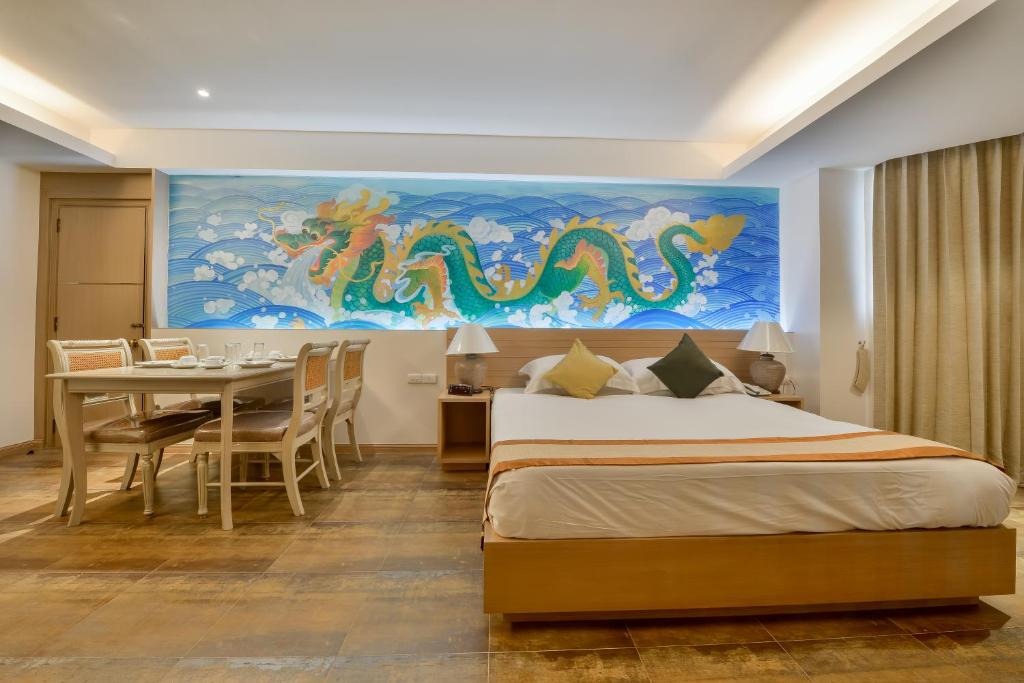 a bedroom with a bed and a dining table at The Grand Sathorn in Bangkok