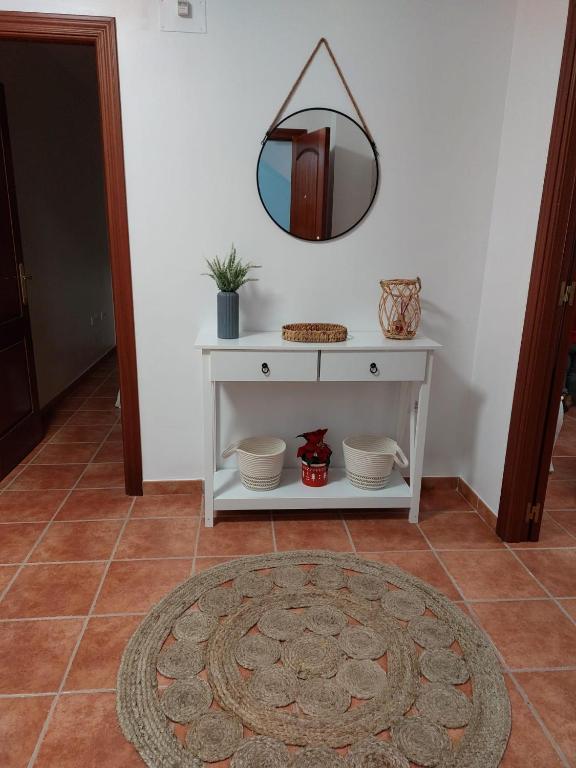 a room with a white table with a mirror on the wall at La Labranza del Bosque in El Bosque