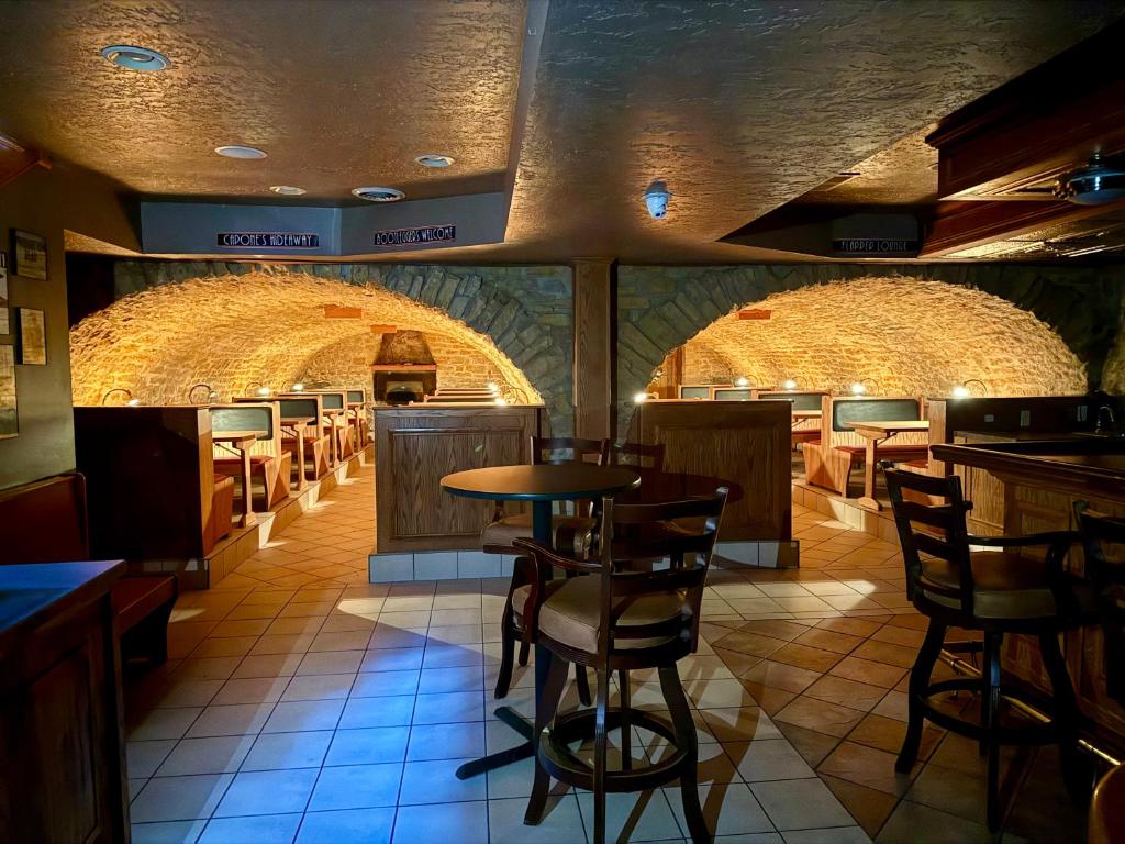 a restaurant with a bar with chairs and tables at Wenzil Taylor Building in Spillville