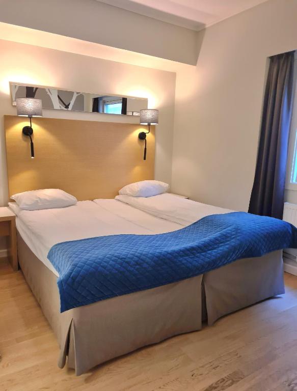 Postel nebo postele na pokoji v ubytování City Living Sentrum Hotel