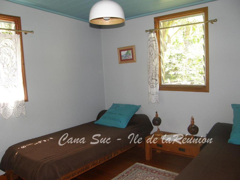 a bedroom with a bed and a window at Cana Suc in Sainte-Rose