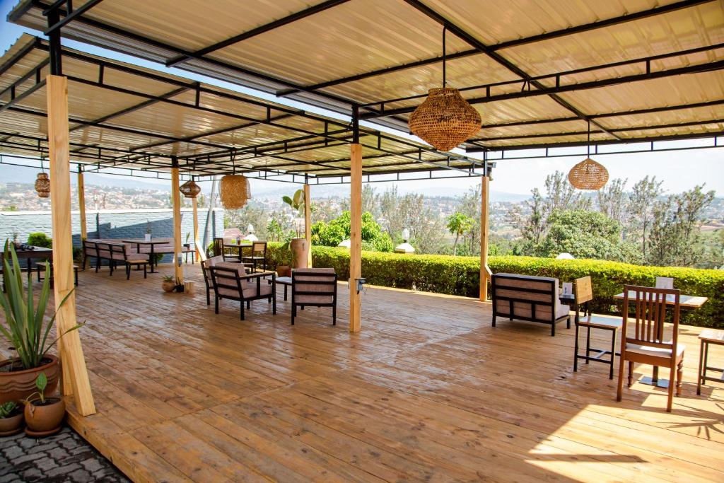 a pavilion with tables and chairs on a wooden deck at YO ki GA li in Kigali