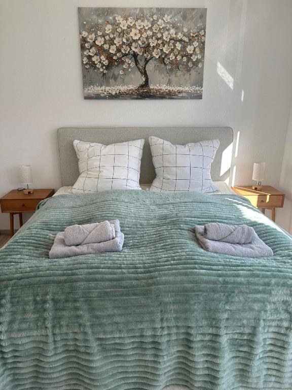 a bedroom with a bed with two towels on it at Yellow one in Magdeburg