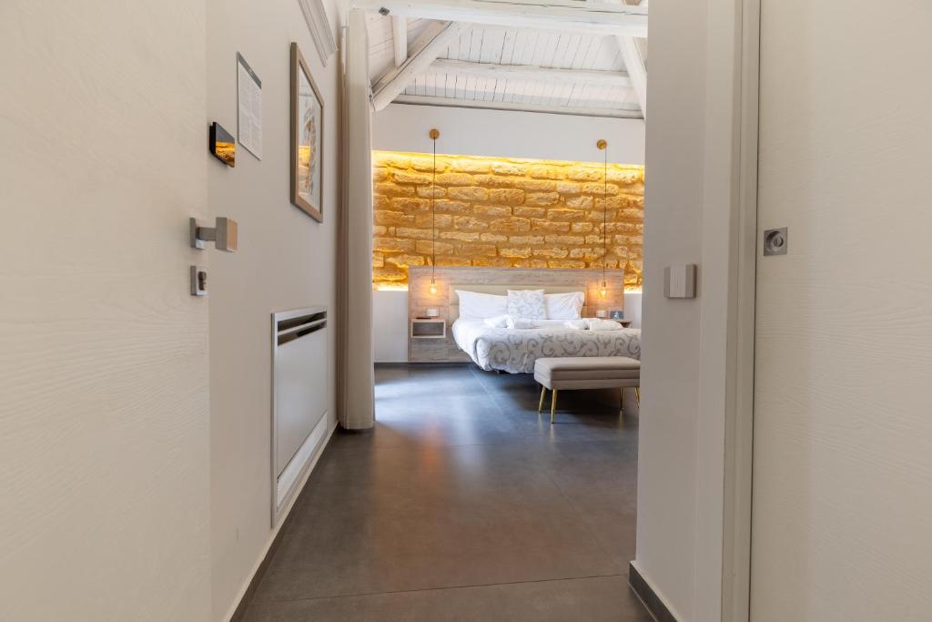 a bedroom with a bed and a couch in a room at Oneira Rooms in Agrigento