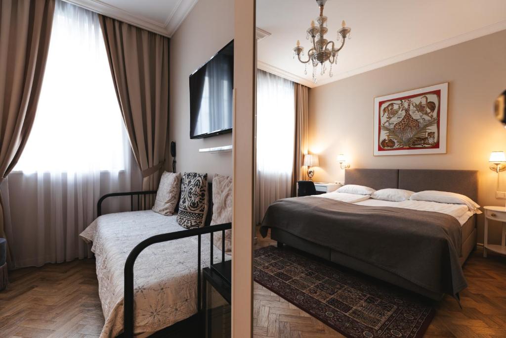 Postel nebo postele na pokoji v ubytování Forums Boutique Hotel