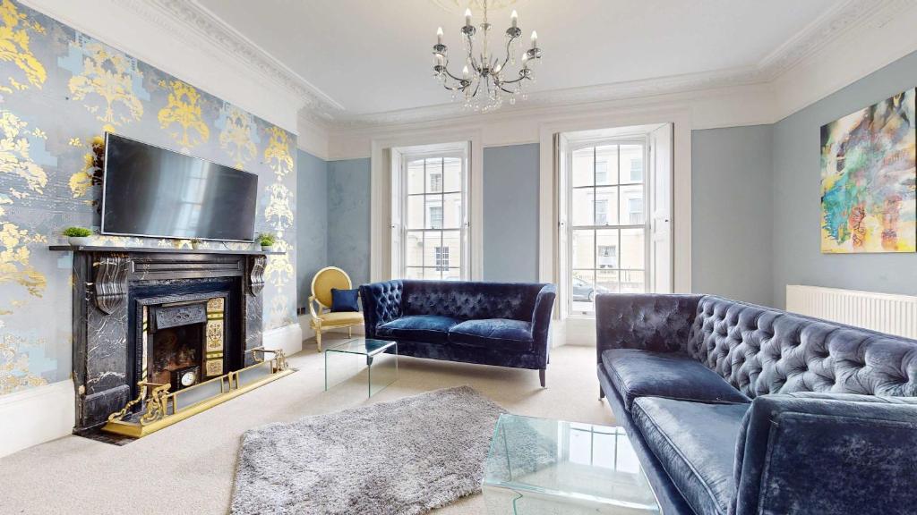 a living room with a couch and a fireplace at THE HOE, BEAUTIFUL 5-BEDROOM HOUSE, GARDEN, SECURE PARKING, SLEEPs 12 in Plymouth