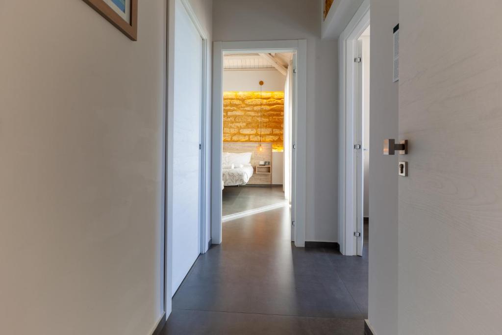 a hallway leading to a bedroom with a bed at Oneira Rooms in Agrigento