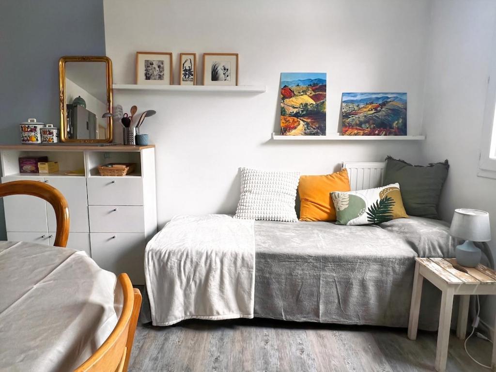 une petite chambre avec un lit et un miroir dans l'établissement Studio cosy près de Paris et de l'Aéroport CDG, à Drancy