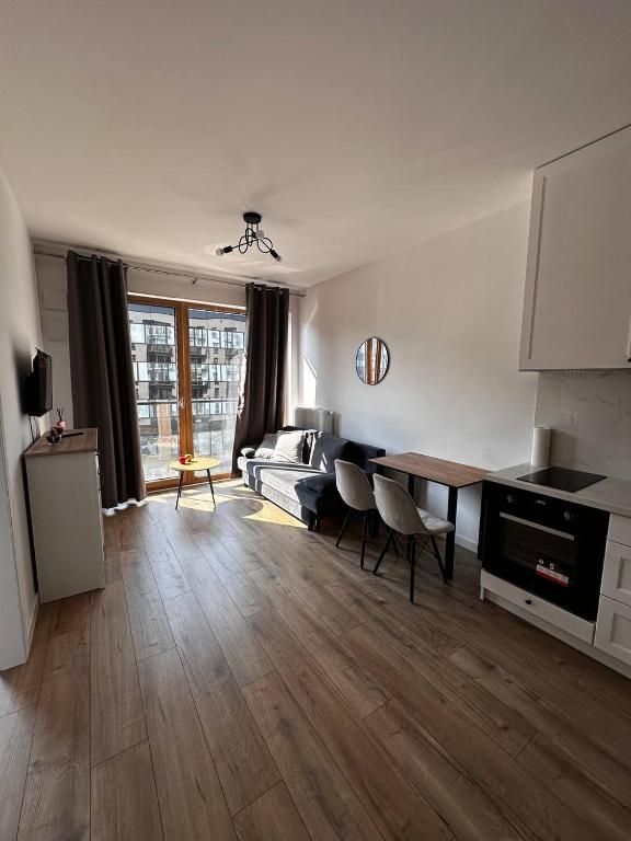 a living room with a couch and a table at A63 by Real Apartment in Warsaw