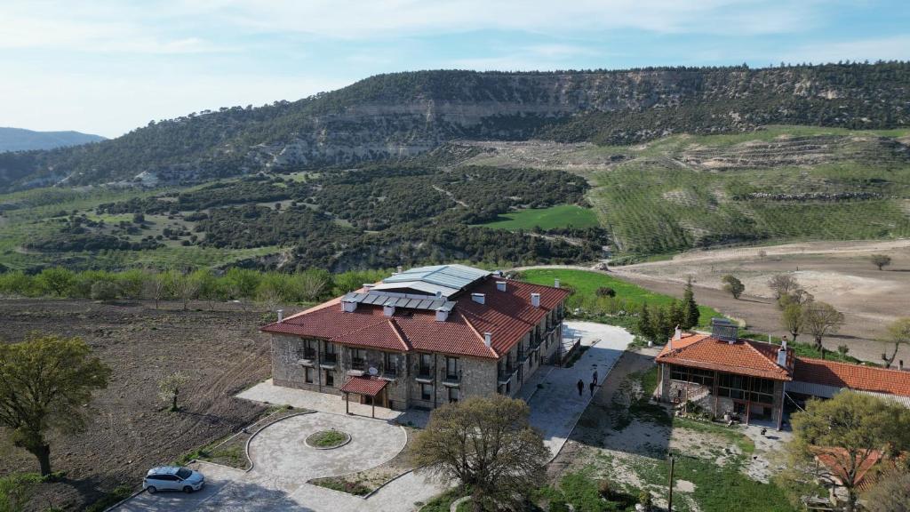 an aerial view of a house on a hill at Bademli Han Otel in Ulucak