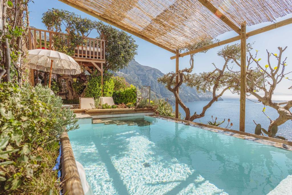 a swimming pool with a view of the water at POSEA Collection - Villa Ponente in Positano