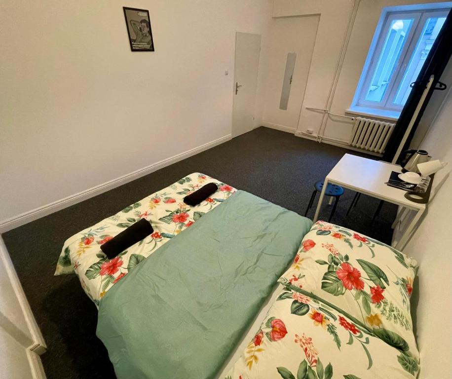 a room with a bed with a blanket on the floor at Fantastic-Inn Warszawa - Chmielna in Warsaw