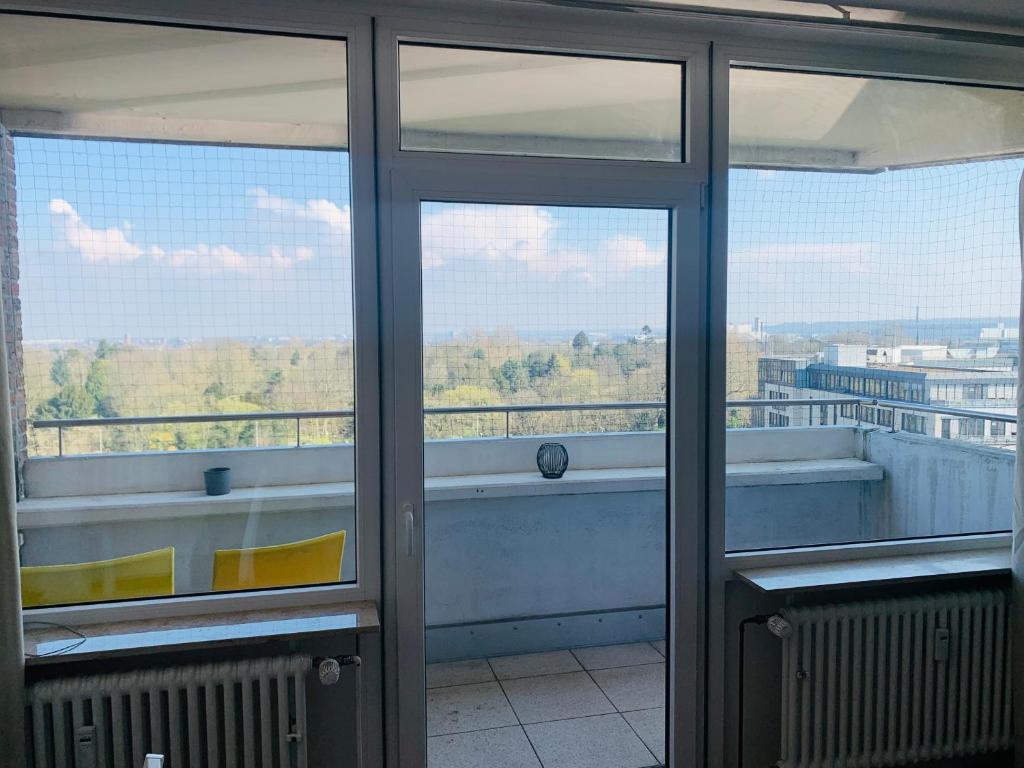 a room with glass doors and a view of a balcony at Business Messe Apartment & Wellness Spa in Düsseldorf